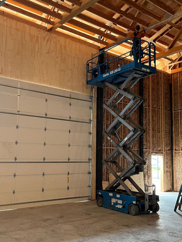Insulated commercial sectional garage door being installed in Eugene, Oregon