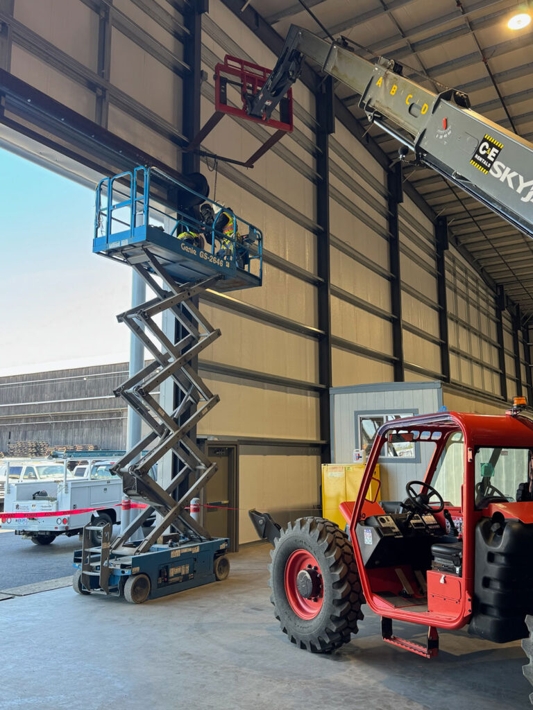Crawford Windor crew on a scissor lift during a commercial garage door install
