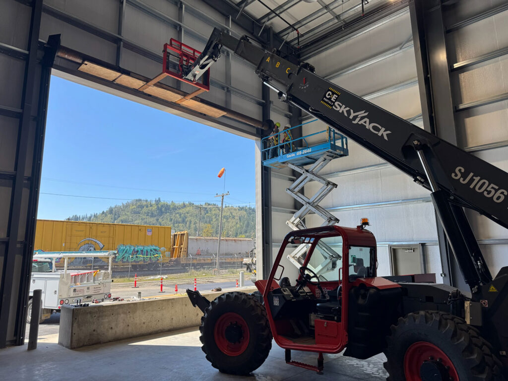 Commercial garage door installation in progress inside a steel building