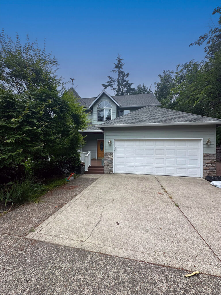 Two-story home with a white double garage door in Eugene, Oregon