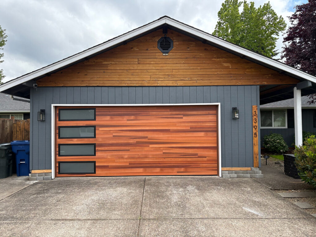 Contemporary home with a horizontal wood-slat and dark garage door in Eugene, Oregon