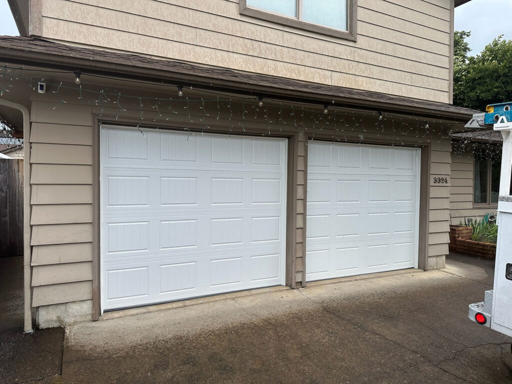 Two white sectional residential garage doors in Eugene, Oregon