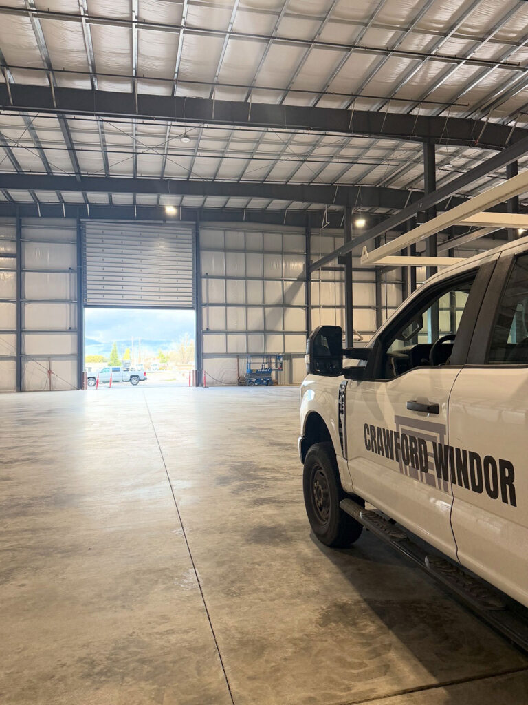 Crawford Windor service truck inside a commercial building with an open bay door