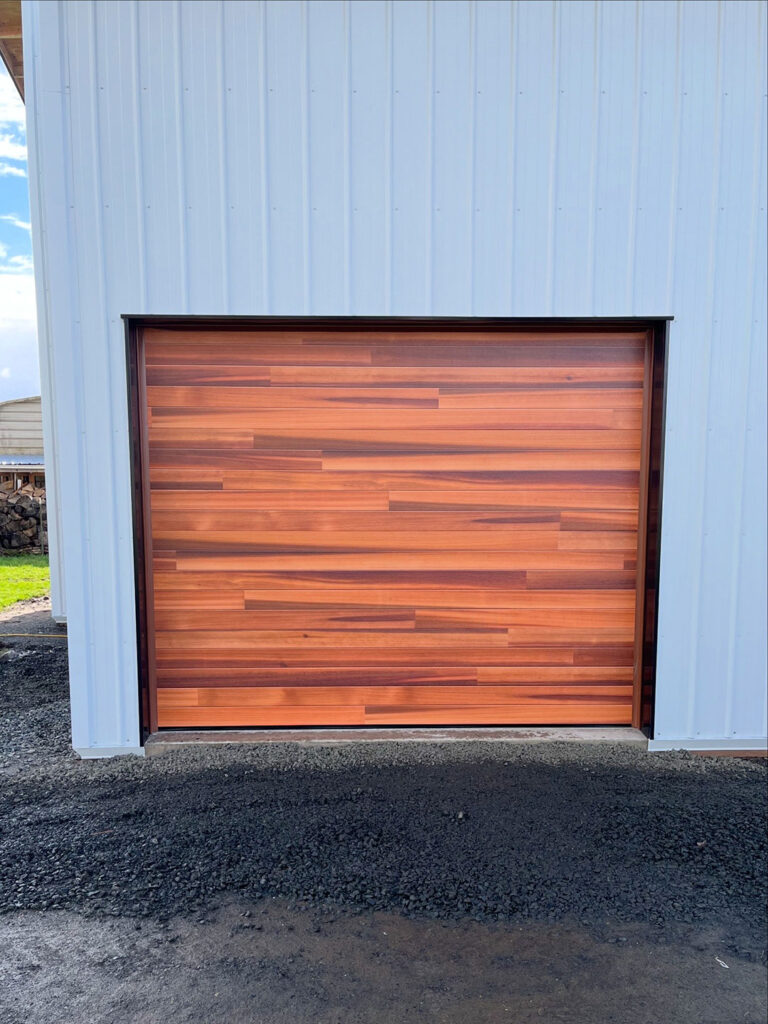 Natural wood-finish sectional garage door on a commercial building