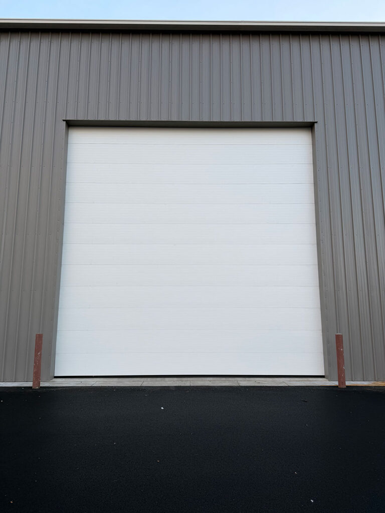 White commercial sectional garage door installed by Crawford Windor