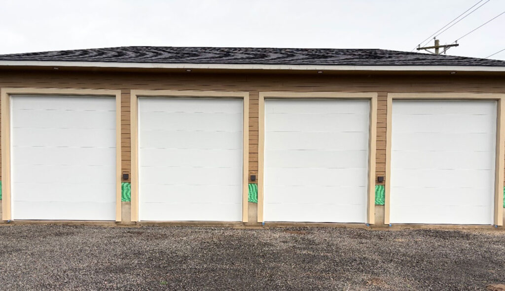 Closed residential garage doors in Eugene, Oregon, where a garage door opener not working is usually down to power, sensors or the remote