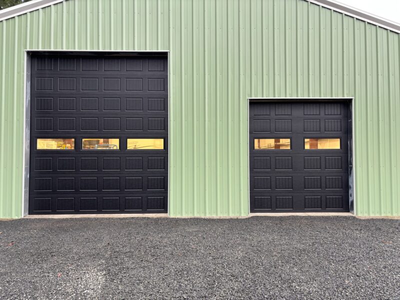 Two commercial overhead doors on a steel building in Lane County, Oregon
