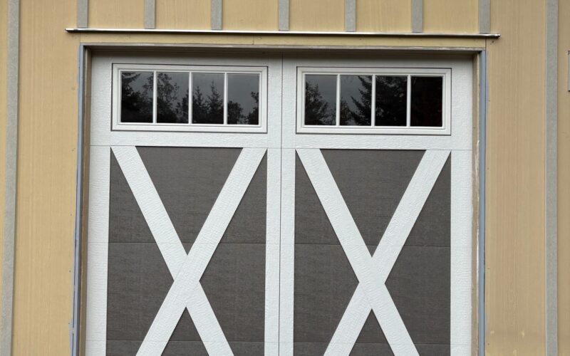 Custom carriage-style garage doors with upper windows on a home near Eugene, Oregon