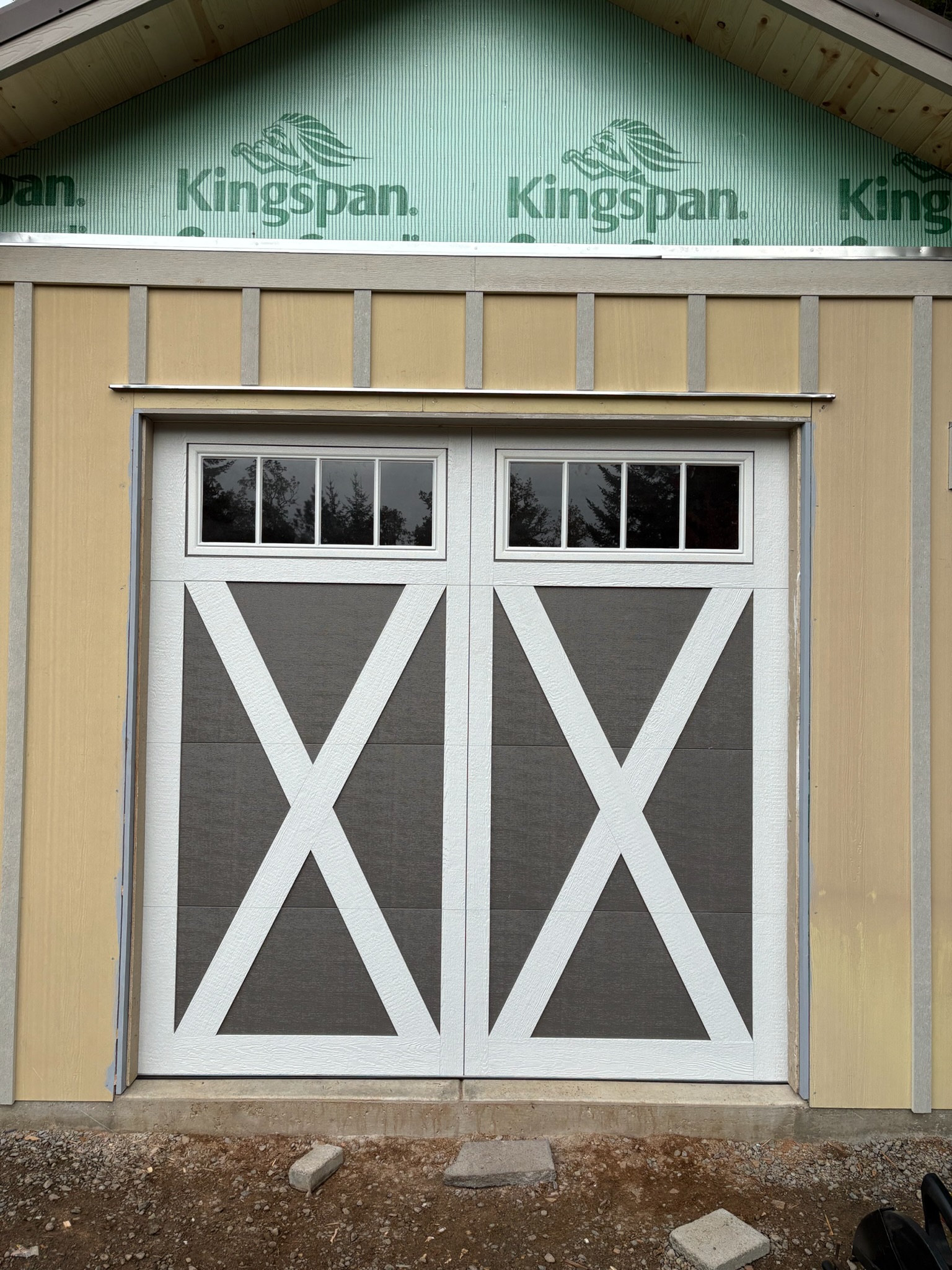 Custom carriage-style garage doors with upper windows on a home near Eugene, Oregon