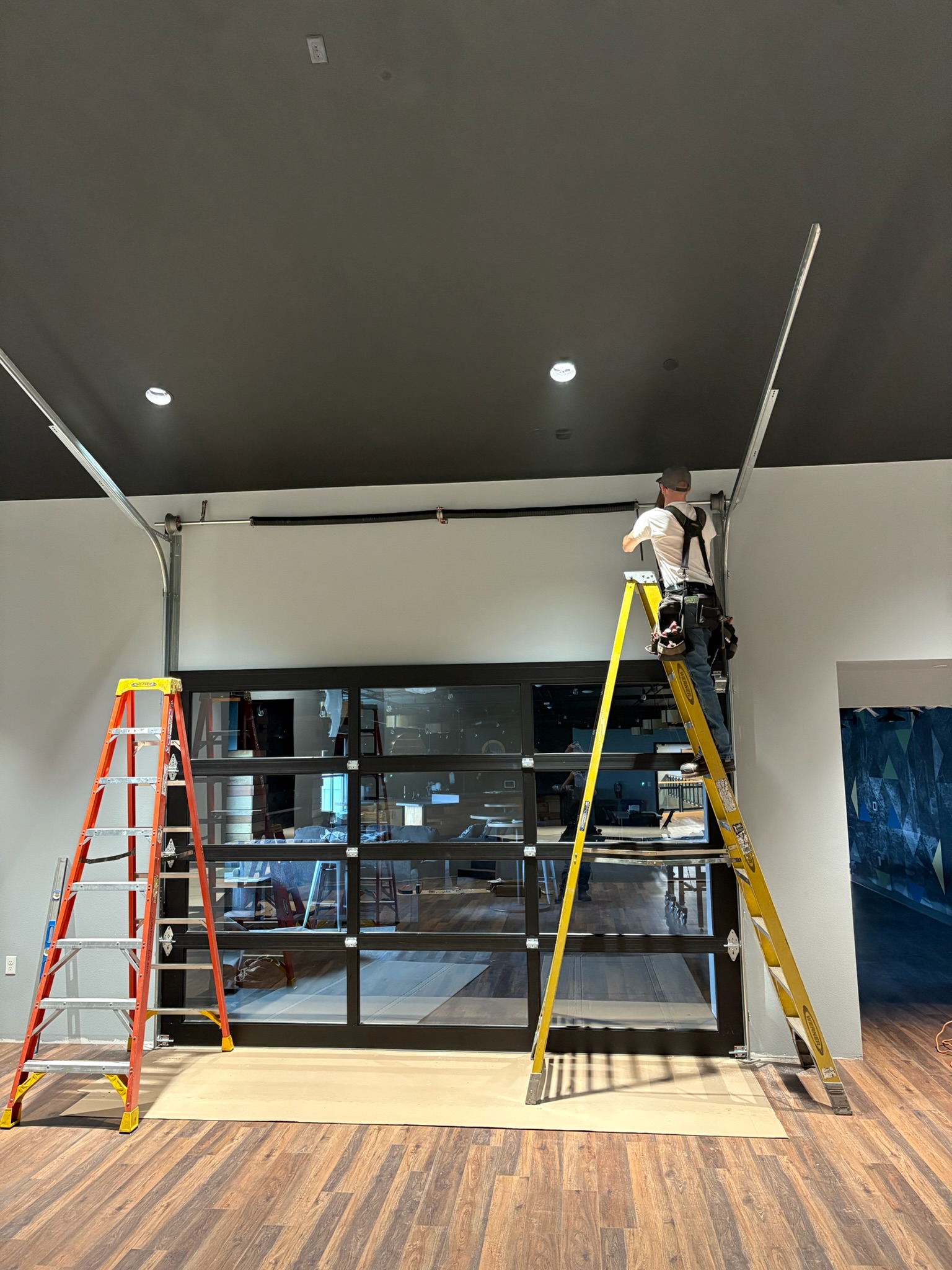 Crawford Windor technician fitting a garage door on a job site in Eugene, Oregon