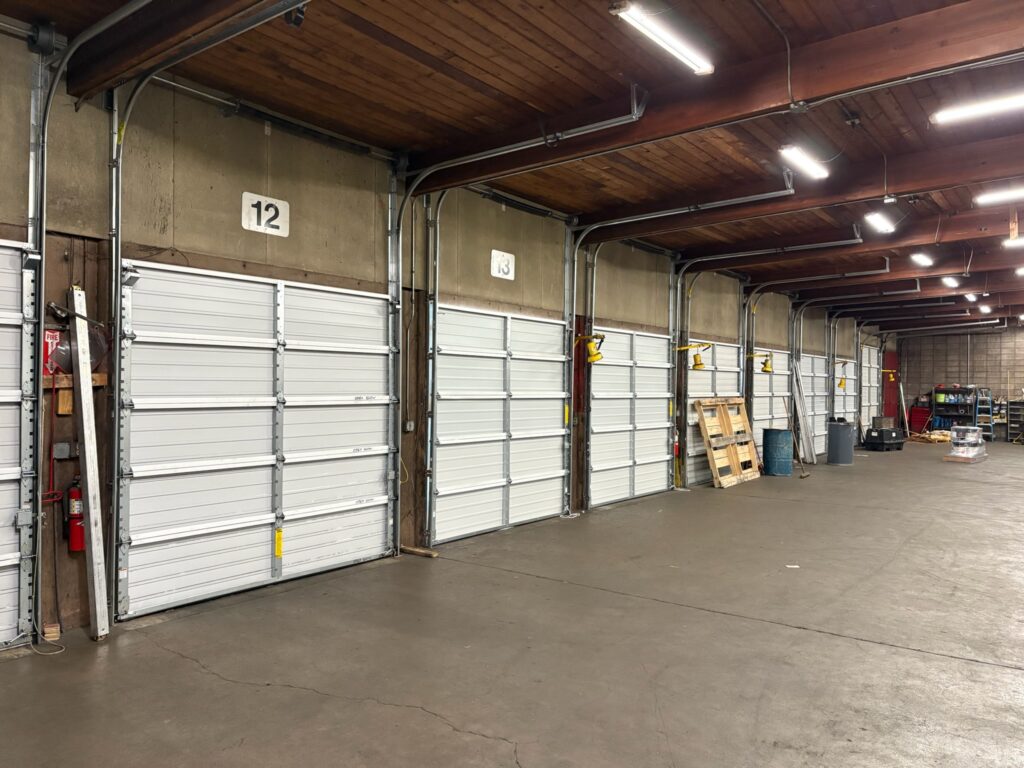 A row of commercial garage doors along the inside of a warehouse near Eugene, Oregon