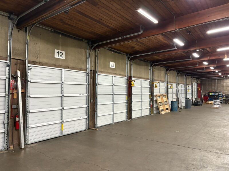 Row of industrial garage door bays inside a warehouse near Eugene, Oregon