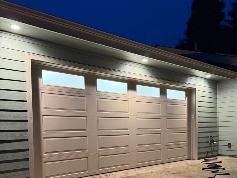 Wood-look sectional residential garage door on a home in Eugene, Oregon